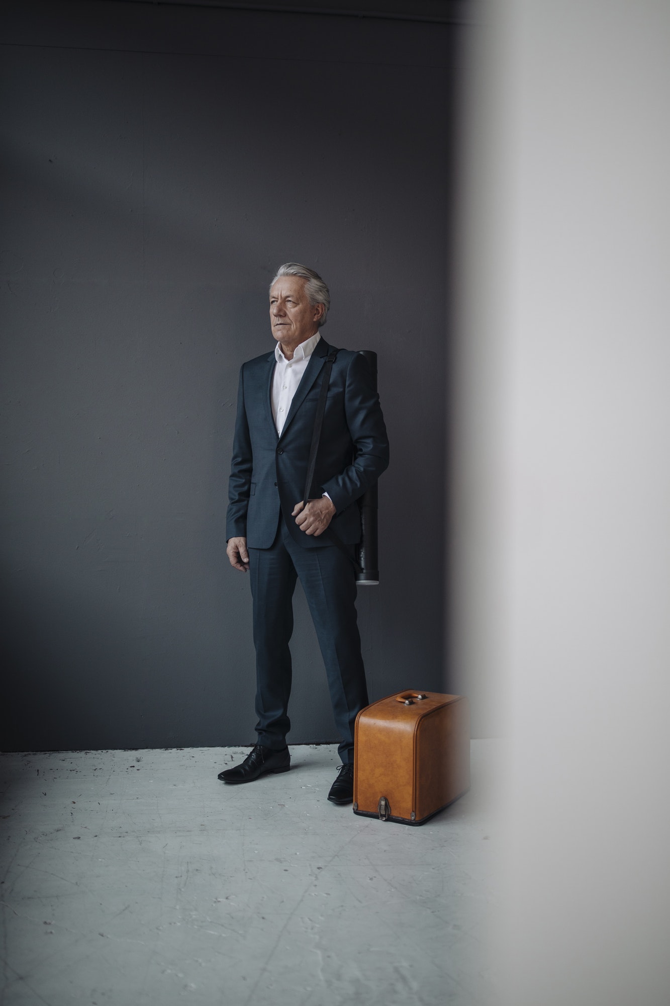 Senior businessman with old-fashioned suitcase